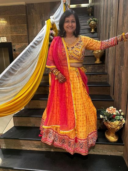 One of my happy clients looking radiant at a Mehendi or Haldi ceremony in a custom-fit yellow and pink lehenga. I love helping you find the perfect colors and styles to celebrate your special moments.