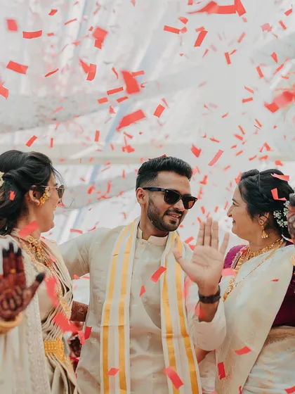 The groom celebrating with his family under a shower of confetti. I choreograph these moments to create stunning photo opportunities filled with joy.