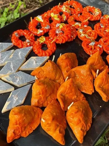 Light up your Diwali with these quirky, handcrafted candles. This set includes candles shaped like popular Indian sweets and snacks, such as jalebi, samosa, and kaju katli, adding a fun and unique touch to your festive decor.