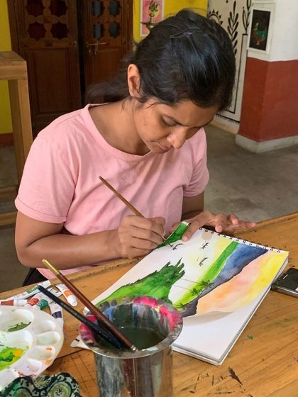 A student from our 2-day workshop works on a watercolor landscape. It's amazing to see the transformation from a blank canvas to a beautiful scene in just a short time.