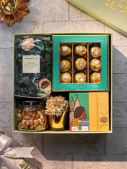 A top-down view of the 'Royal Blend' hamper, showing the beautiful textures and arrangement of the potpourri, chocolates, nuts, and incense.