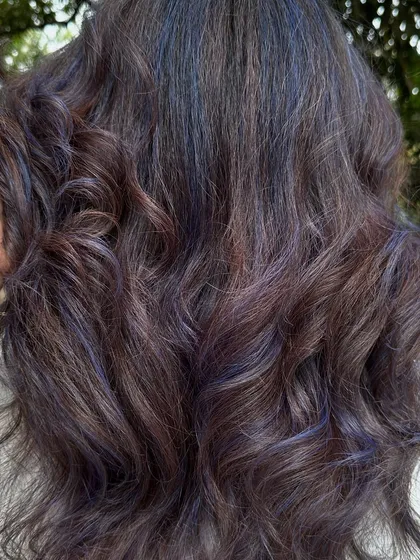 For my experimental clients like Bhakti, we love to play. This time we went for a cool purple and blue mix on her curly hair. The color looks so different after a few washes, fading into a beautiful pastel tone.