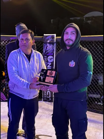 Our coach receiving an honor from the One Impact organization at the Elite Combat event in Ajmer.