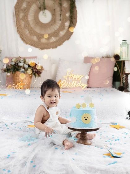 A "Sunshine" themed cake smash is perfect for a bright and happy first birthday. The mix of confetti, a custom cake, and a happy baby makes for a perfect shot.