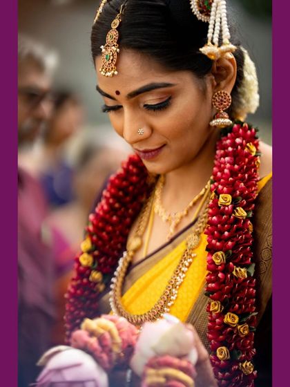 A candid shot of Nithyashri during her muhurtha rituals. Her makeup was designed to be sweat-proof and long-lasting, ensuring she looked fresh and flawless throughout the entire ceremony.