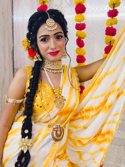 A Haldi look should be bright, fresh, and fun. Here, I've used a pop of colour on the lips and kept the base dewy to match the vibrant yellow outfit and floral jewellery, making sure the bride glows.