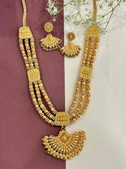 Celebrating the beauty of heritage with this stunning multi-layered gold necklace and earring set. It embodies the grace of our culture and is perfect for the bride who wants a truly traditional look.