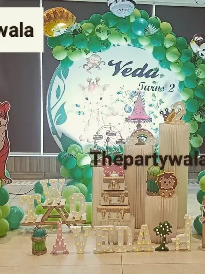 A large jungle theme setup with multiple character cutouts, including a big tiger. The picket fences help to define the party area.