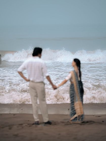 This intentionally soft-focus shot captures the feeling of a dream. With the waves crashing behind them, this image emphasizes the emotion and the atmosphere of a romantic walk on the beach.