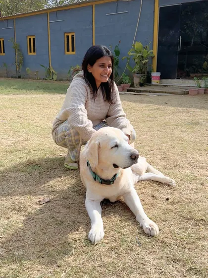 A happy client enjoying a peaceful moment with a relaxed Labrador. Our space is welcoming for both dogs and their humans.