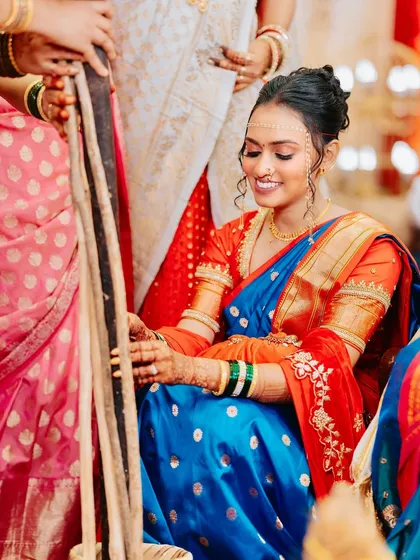 A candid moment during the wedding rituals. The bride's makeup, featuring rose gold lids and a modern hairstyle, perfectly blends tradition with contemporary style.