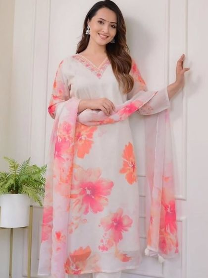 This off-white premium organza kurta has a beautiful watercolor floral print. It's a soft, feminine, and elegant piece for any special occasion.