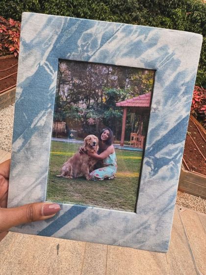 A photo frame covered in naturally dyed fabric. This was part of a festive gift hamper and is a lovely way to display your favorite memories with a touch of handmade charm.