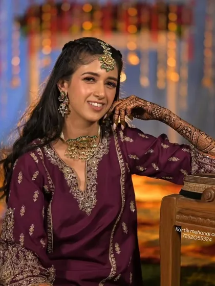 A stunning portrait of a client at an evening function, her intricate mehandi catching the light beautifully.