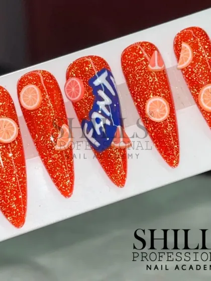 A fun, branded nail art design inspired by Fanta, featuring a glittery orange base and tiny 3D orange slice details.