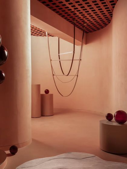 This abstract view shows the interplay of curved forms, from the large columns to the suspended glass art. The space was designed to be beautiful from every angle, even in its quietest moments.