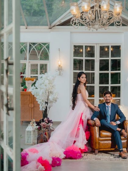 A beautifully framed view of the couple through the doorway, creating a sense of looking into a private, romantic world.