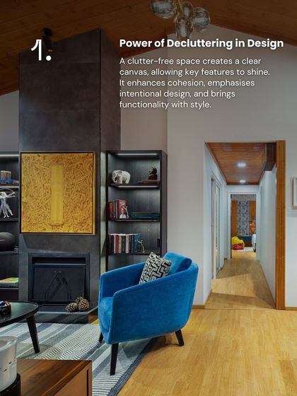 A clutter-free space allows key features to shine. In this living area, the absence of clutter enhances the impact of the fireplace, the bold blue Ava chair, and the thoughtfully curated bookshelves, creating a room that feels intentional and stylish.