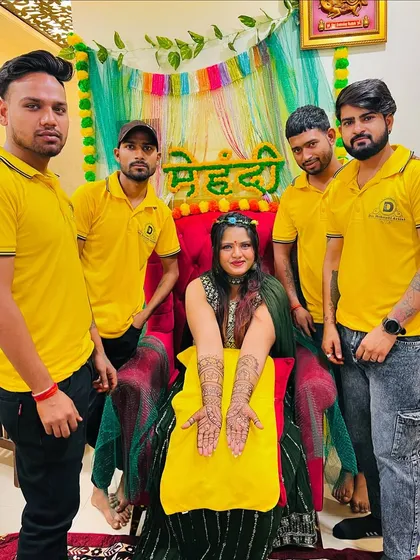 Our team posing with a happy bride on her special day. Our goal is to make your mehndi ceremony unforgettable.