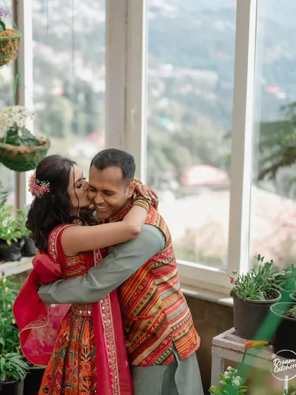A sweet, candid hug between the couple during their carnival-themed event in Mussoorie. The greenhouse setting provided a beautiful, lush backdrop for their celebration.