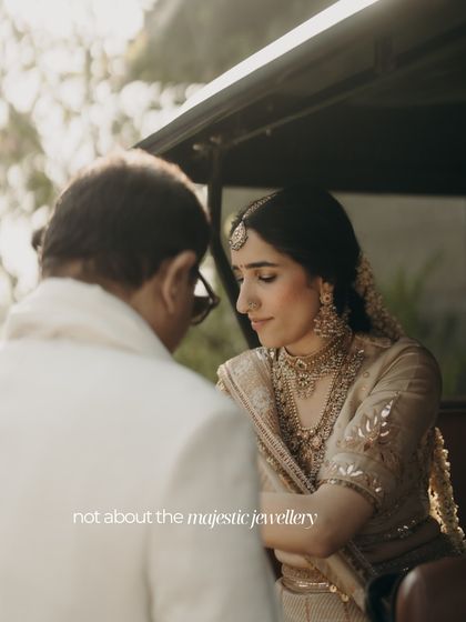 A bride in a quiet moment with her father. This image illustrates our philosophy of 'Context before Couture', focusing on personal moments and details that hold meaning beyond the wedding day.
