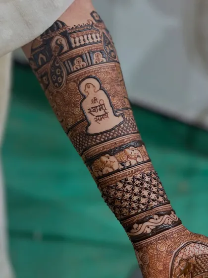 The full arm view of the spiritual design, showing how the Swami Samarth motif is integrated into a traditional bridal mehendi pattern.