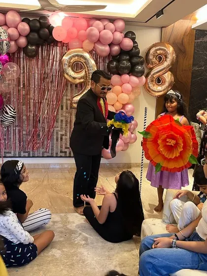 My shows are filled with colourful and surprising props. I'm using a bouquet of flowers that magically appears to amaze the kids at this fun-filled 9th birthday party.