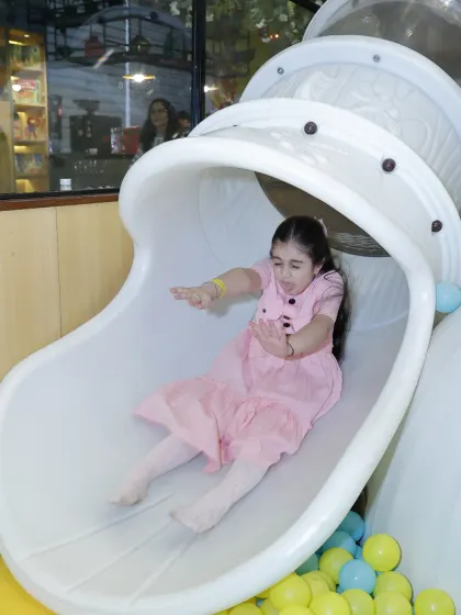The pure thrill of our enclosed spiral slide, ending in a soft landing in the ball pit.