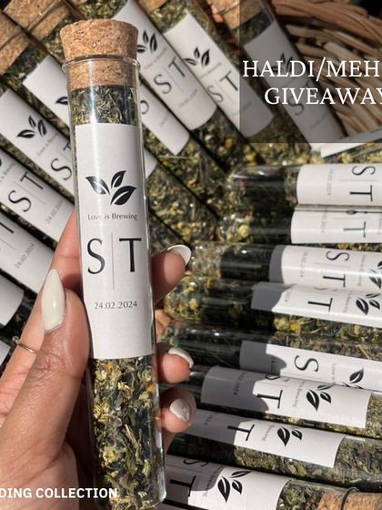 For Haldi or Mehndi giveaways, these "Love is Brewing" tea tubes are a unique and thoughtful favor. Each tube is personalized with the couple's initials and wedding date.