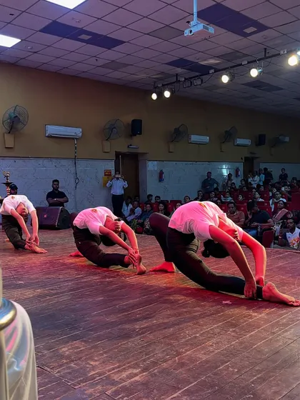A synchronized deep forward bend performed by my students, showcasing incredible flexibility during the Yog Mahakumbh event.