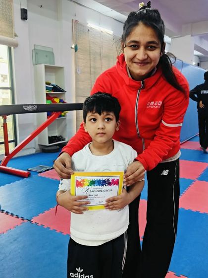 A proud moment for this young student receiving his certificate.