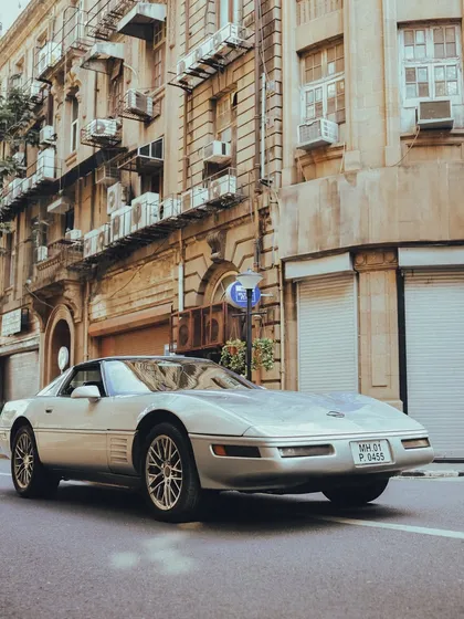 A rare sight. This classic silver Chevrolet Corvette adds a touch of American muscle to the streets of South Bombay.