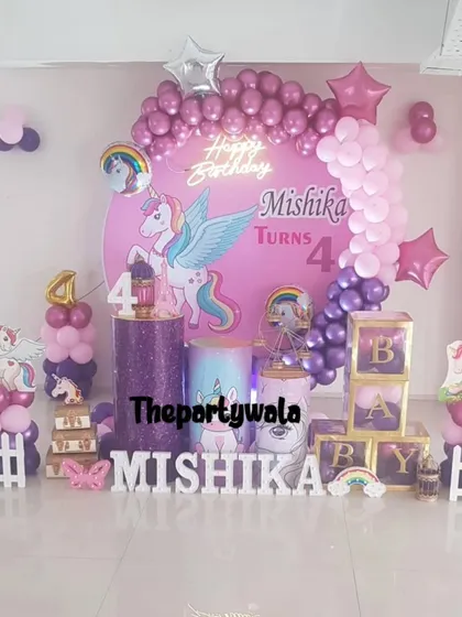 A beautiful unicorn theme with a winged unicorn (alicorn) as the centerpiece. The purple and pink color scheme with "BABY" blocks is perfect for a magical first birthday.