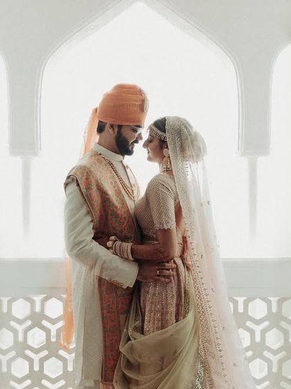 A stunning silhouette against a bright, airy backdrop. This portrait is both regal and modern, using the architectural elements of the venue to create a high-contrast, artistic image.