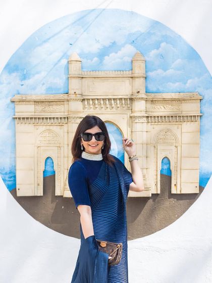 A chic solo portrait of the bride-to-be. Her modern saree and confident pose against the iconic backdrop make for a fashionable shot.