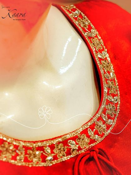 A close-up of the neckline of our red velvet kurta. The gold zardosi and floral embroidery provide a rich, luxurious detail that elevates the entire outfit.