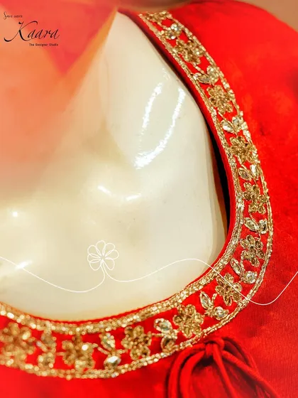 A close-up of the neckline of our red velvet kurta. The gold zardosi and floral embroidery provide a rich, luxurious detail that elevates the entire outfit.