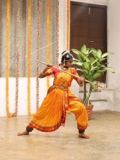 A young dancer performs a piece with a staff, showcasing a unique blend of dance and martial arts at our Platform Performance event.