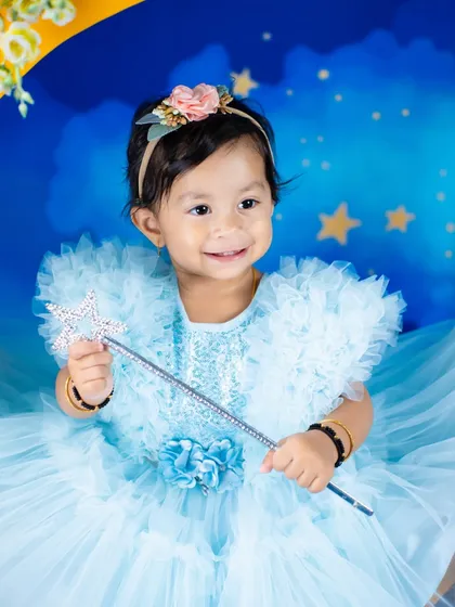 A close-up of a sparkling smile that deserves all the love. The magic wand and starry background make this a truly enchanting portrait.