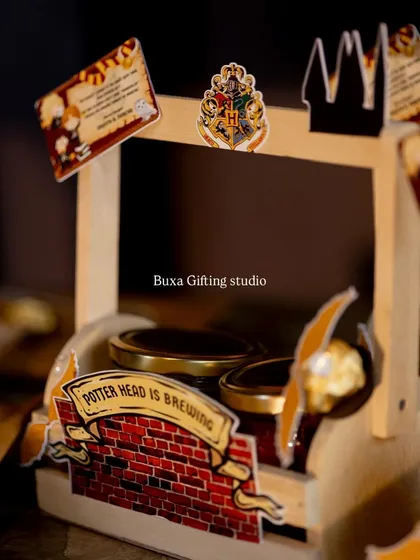 A budget-friendly version of the Harry Potter hamper, featuring themed stickers on a simple wooden basket filled with treats.