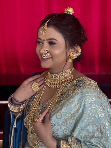 A close-up of the client, showing how beautifully the jewellery complements the pastel blue saree.