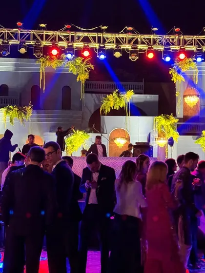 Guests mingling and dancing at an elegant sangeet. I curate playlists that work for every part of the evening, from early conversations to late-night dancing.
