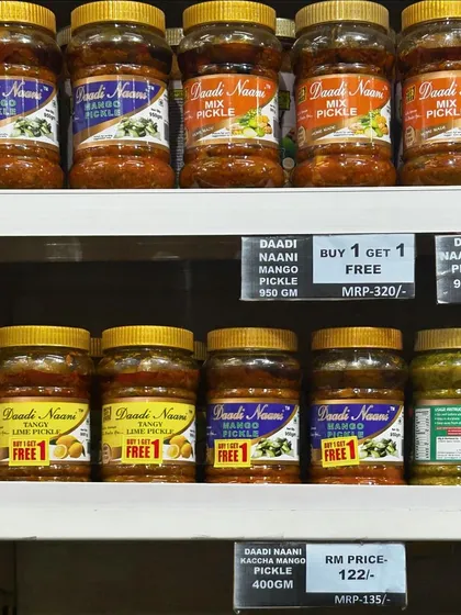 Our pickles lined up on a store shelf. We offer different sizes and often have special deals like 'Buy 1 Get 1 Free' on select varieties like our Mango and Mix pickles.