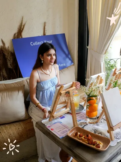 A guest enjoying the painting station at a creators brunch. We provide all the materials, from canvases and easels to paints and brushes, for a complete and hassle-free activity.