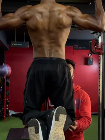 Here I am assisting my client with pull-ups. My coaching ensures that even experienced lifters are pushing their limits and maintaining proper form.