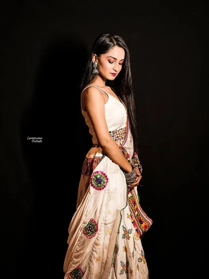 A side profile portrait capturing the quiet elegance of the Navratri look, with a focus on the drape of the lehenga and the model's serene posture.