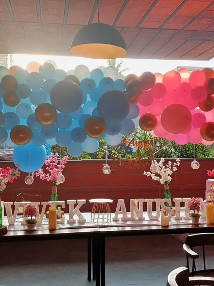 This impressive balloon wall is perfect for a gender reveal. One side is filled with shades of blue and the other with shades of pink, creating a dramatic and fun backdrop for the big announcement.