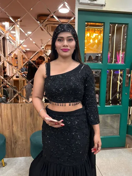 A perfect example of a chic and modern party look. We styled this client in a stunning black sequin saree with sleek, straight hair and glamorous makeup, including a bold lip and defined eyes, ensuring she stands out at her event.