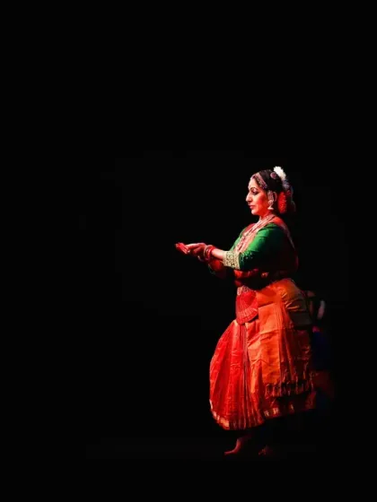 A moment of quiet contemplation on stage, surrounded by the digital cosmos of our AI-driven performance. The stark contrast of light and shadow highlights the dancer's form against the complex visuals.