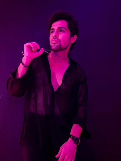 All black, all confident. A shot from a moody and stylish photoshoot, playing with lights and shadows.